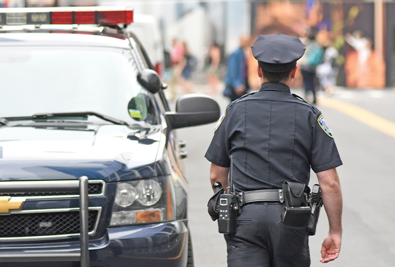 Police officer by car