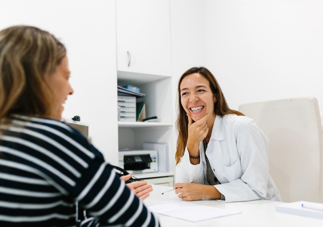 Smiling female doctor caring for a patient