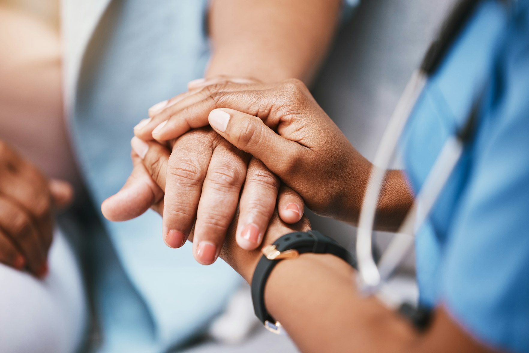 Nurse holding patients hand