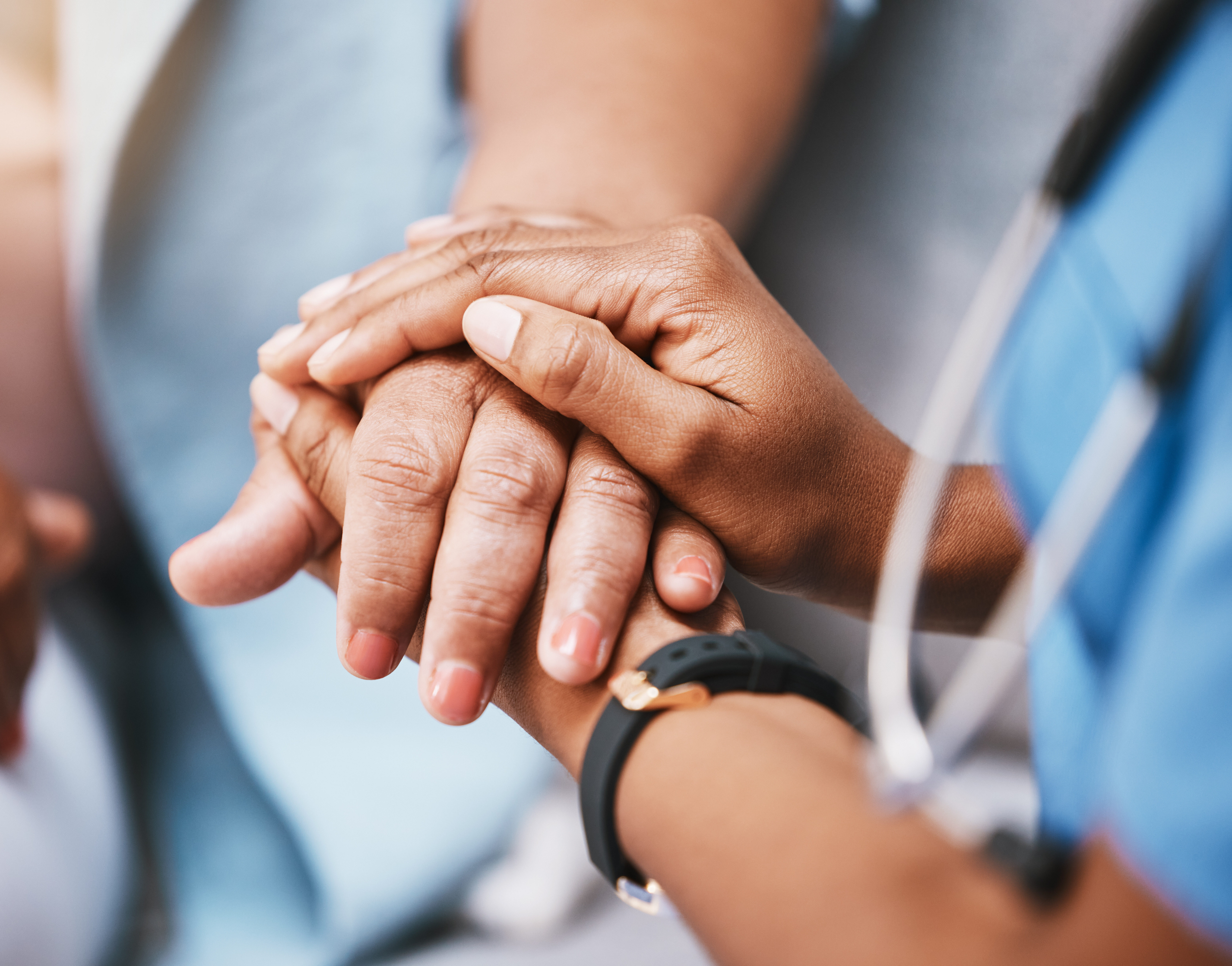 Nurse holding patients hand