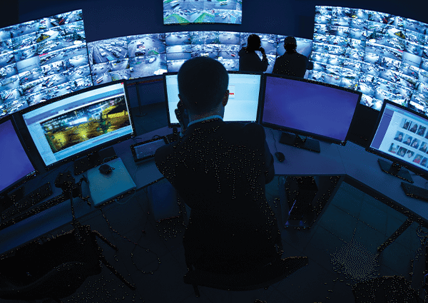 Unified aim scs interface man reviewing computer screens
