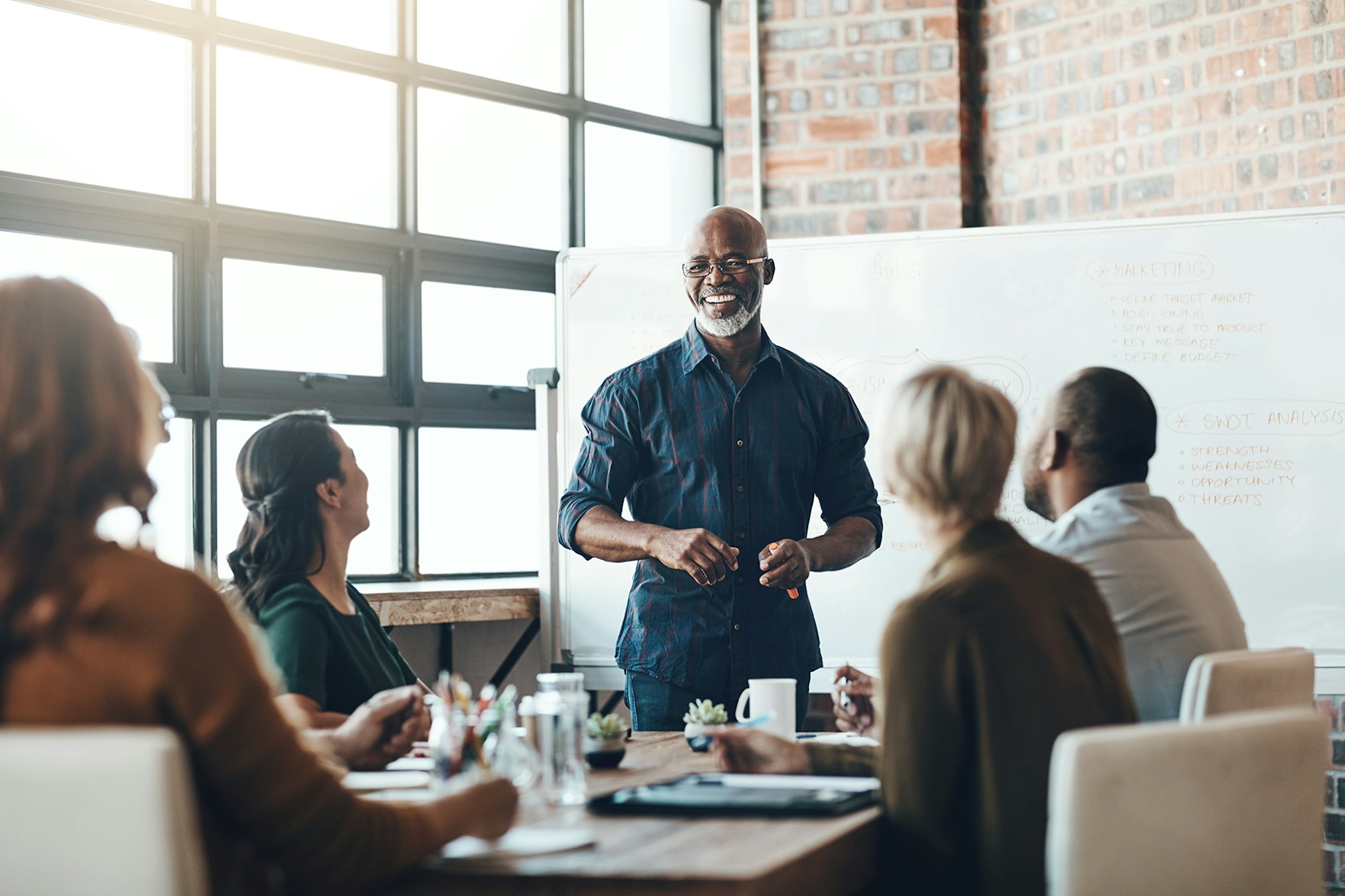 Coworkers sitting in meeting tailored services